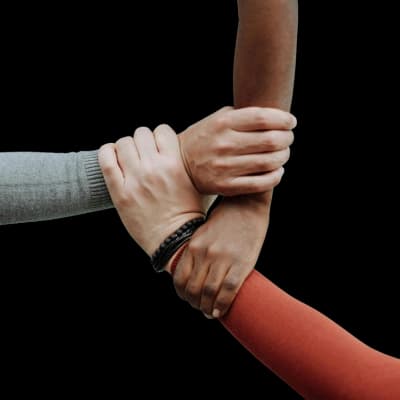 Three hands gripped together