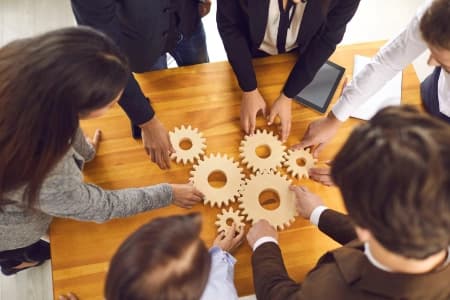Office people working with gears on a table